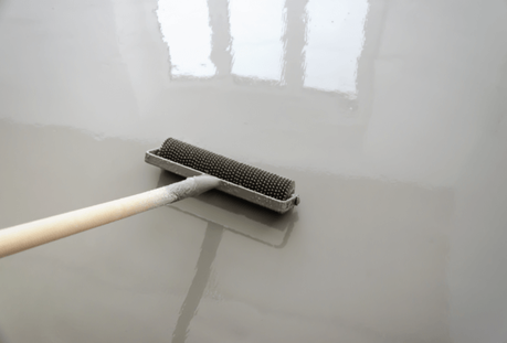 Applying concrete sealer or epoxy to a concrete driveway or garage floor